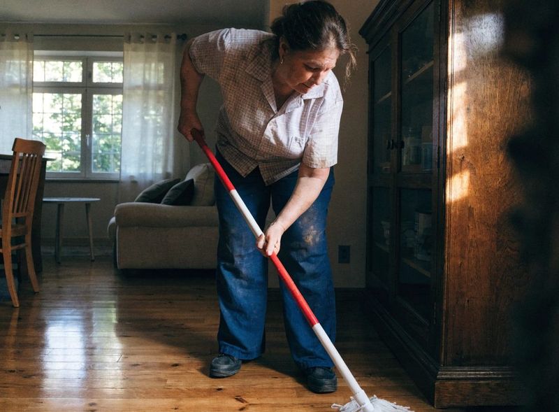 Cleaner mopping a hard floor during Attic Cleaning in Palm Beach, FL