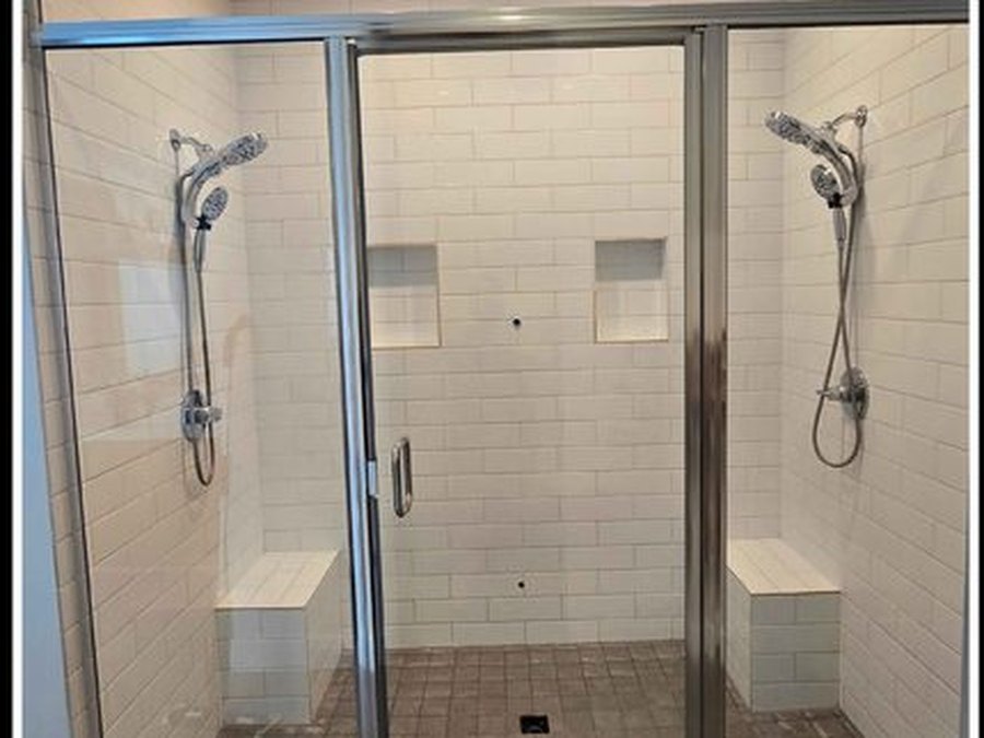 Glass shower enclosure, hard-water film and soap scum removed — after
