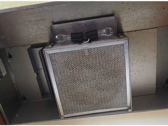 Range hood interior and filter, baked-on grease removed — before