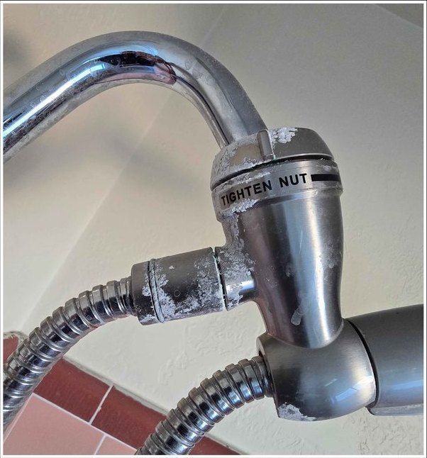 Shower valve and fittings descaled and polished — before