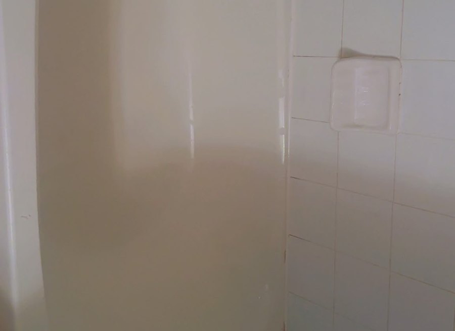 Bathtub surround, mould in the caulk line and hard water removed — after