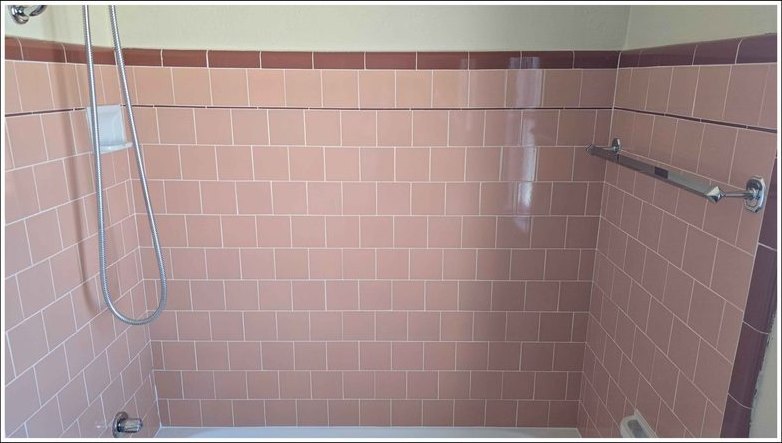 Tile and grout brightened around the tub surround — after