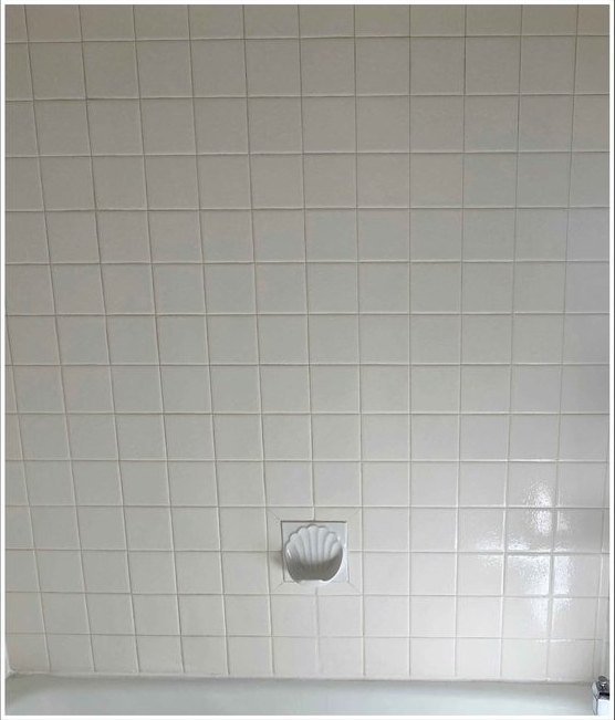Shower wall tile, grime and film removed — after