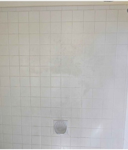 Shower wall tile, grime and film removed — before